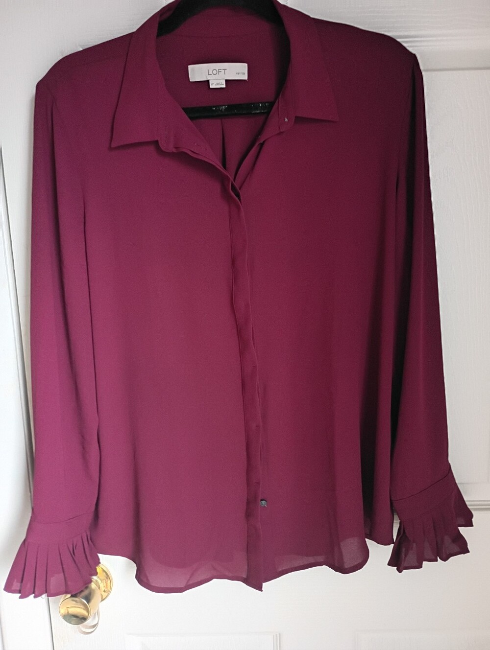 This is a LOFT petite burgundy button-down blouse